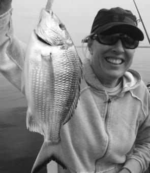 Debbie with a solid bream caught just off the runway.